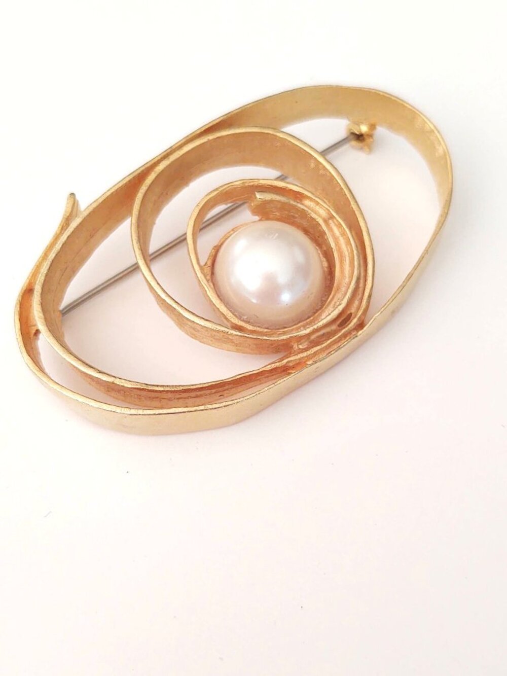 Modernist gold tone and faux pearl brooch